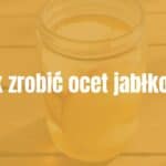 A glass jar filled with homemade apple cider vinegar, sliced apples and water inside, sunlight streaming through the liquid, rustic wooden table background, natural and inviting.